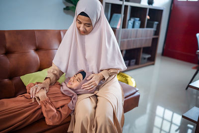 Low angle view of young woman sitting at home