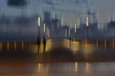 Scenic view of lake seen through wet glass