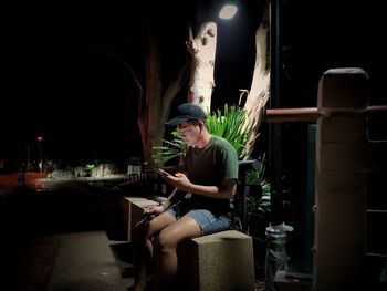 Young woman sitting on table in restaurant at night