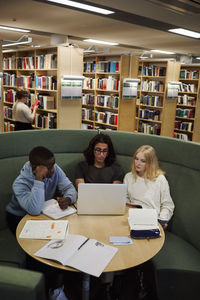 Students learning together in library