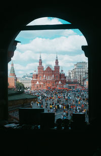 Buildings in city against cloudy sky