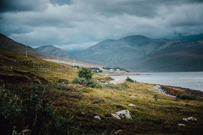 Scenic view of lake and mountains against sky