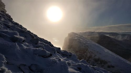 Scenic view of snow covered mountains against sky
