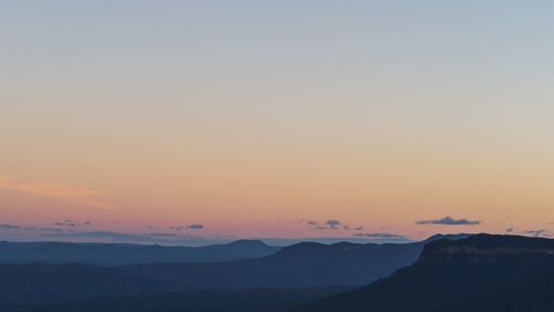 Scenic view of silhouette mountains against sky during sunset