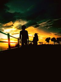 Silhouette of friends at sunset