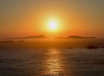 Scenic view of sea against orange sky