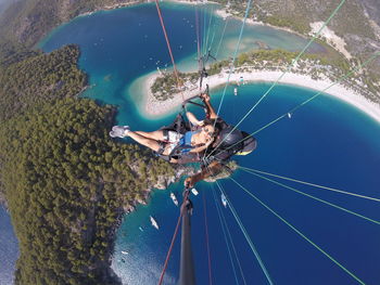 People paragliding over sea during summer