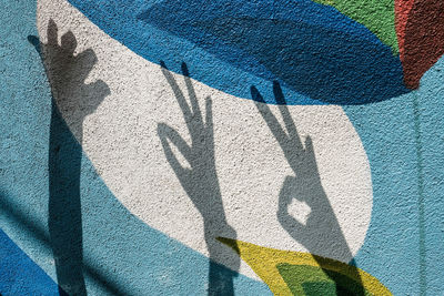 Shadow of hands on painted wall