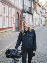 Portrait of young woman walking on street