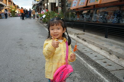 Portrait of smiling girl on road
