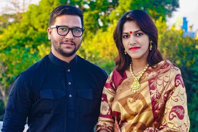 Portrait of young couple against trees