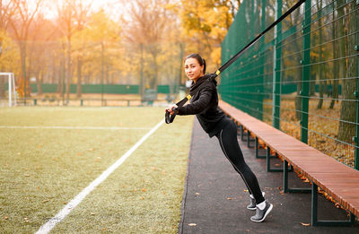 Full length of woman exercising at park