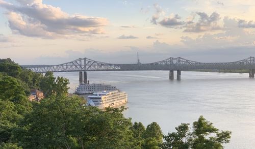 View of bridge over river against cloudy sky