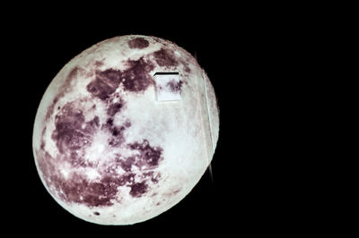 Low angle view of moon in the dark