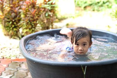 Portrait of cute boy in water