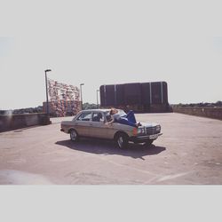 Cars parked on road against clear sky