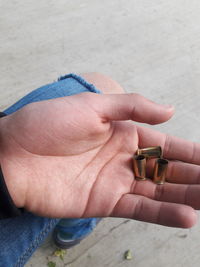 Close-up of hand holding bullet shells