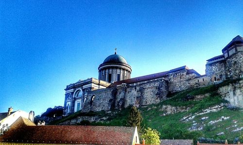 Low angle view of old building against clear blue sky