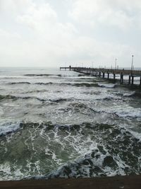 Scenic view of sea against cloudy sky