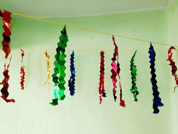 Close-up of multi colored clothes hanging on wall