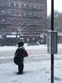 Man on snow covered city in winter