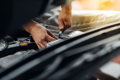 Midsection of man working at garage