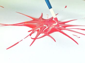 High angle view of red art on white background