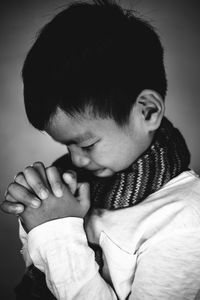 Close-up of boy with hands clasped