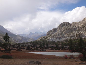 Scenic view of mountains against cloudy sky