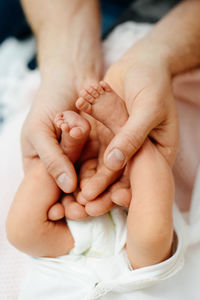 Cropped image of father holding newborn baby