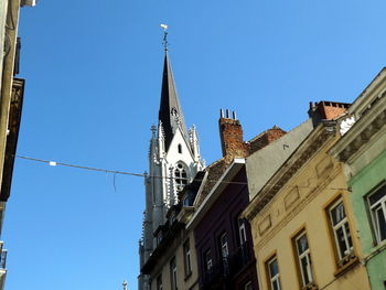 Low angle view of buildings against blue sky