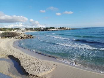 Scenic view of beach against blue sky