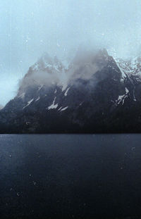 Scenic view of sea and mountains against sky