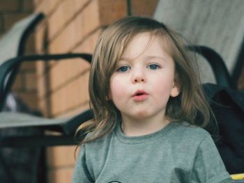 Portrait of cute boy against house