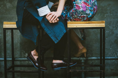 Low section of woman sitting on bench