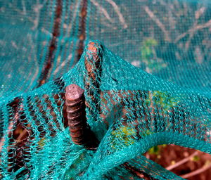 Close-up of fishing net and iron rod