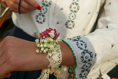 Low section of woman with legs on flower