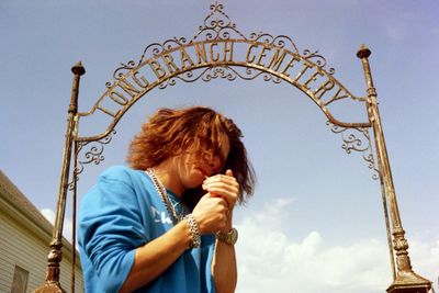 Low angle view of woman smoking cigarette against sky