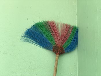 Close-up of multi colored umbrella against wall