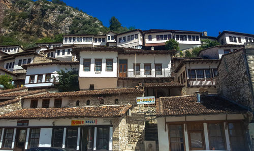 Buildings in city against clear sky