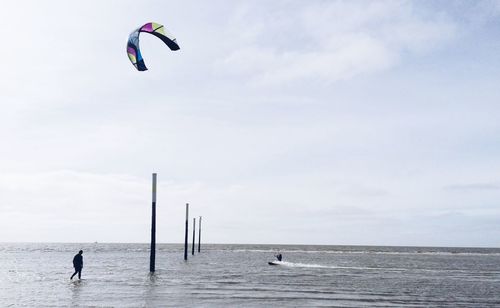 Person kiteboarding in sea