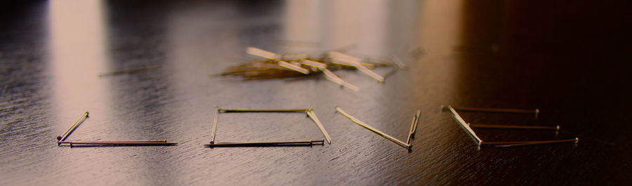 Panoramic shot of love text made from needles on table