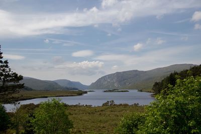 Scenic view of lake and mountains against sky