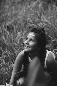 Portrait of smiling young woman sitting outdoors