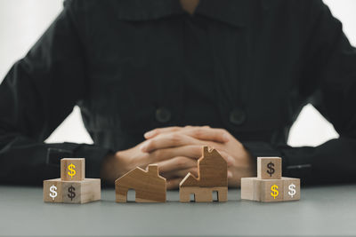 Midsection of man with toys on table