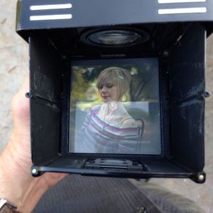 Portrait of woman holding camera