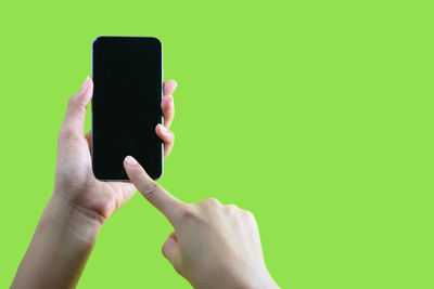 Midsection of man using mobile phone