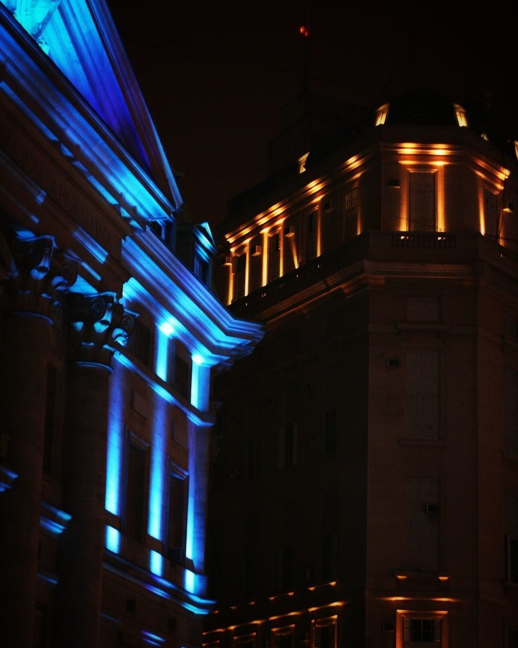 LOW ANGLE VIEW OF ILLUMINATED BUILDING