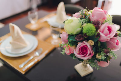 Close-up of pink rose on table