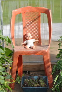Cute girl sitting by plants